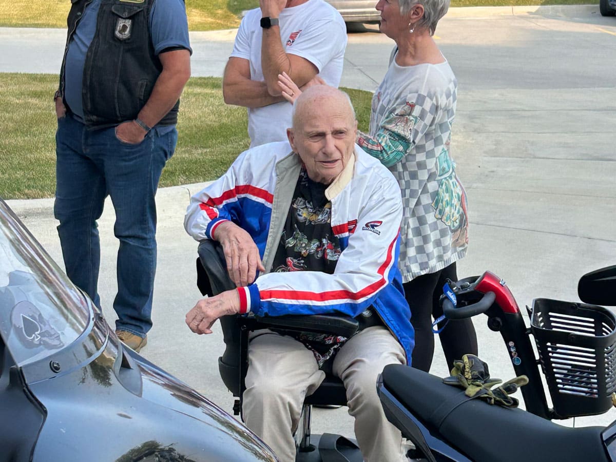 Bruce Beals, a 92-year-old Meadowview of Clive resident and Air Force veteran, smiles as he enjoys his Timeless Dream motorcycle celebration.