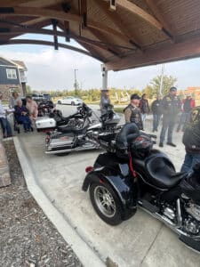 Members of the Combat Veterans Motorcycle Association stand with their motorcycles outside Meadowview of Clive, while Bruce and residents watch and join the gathering.